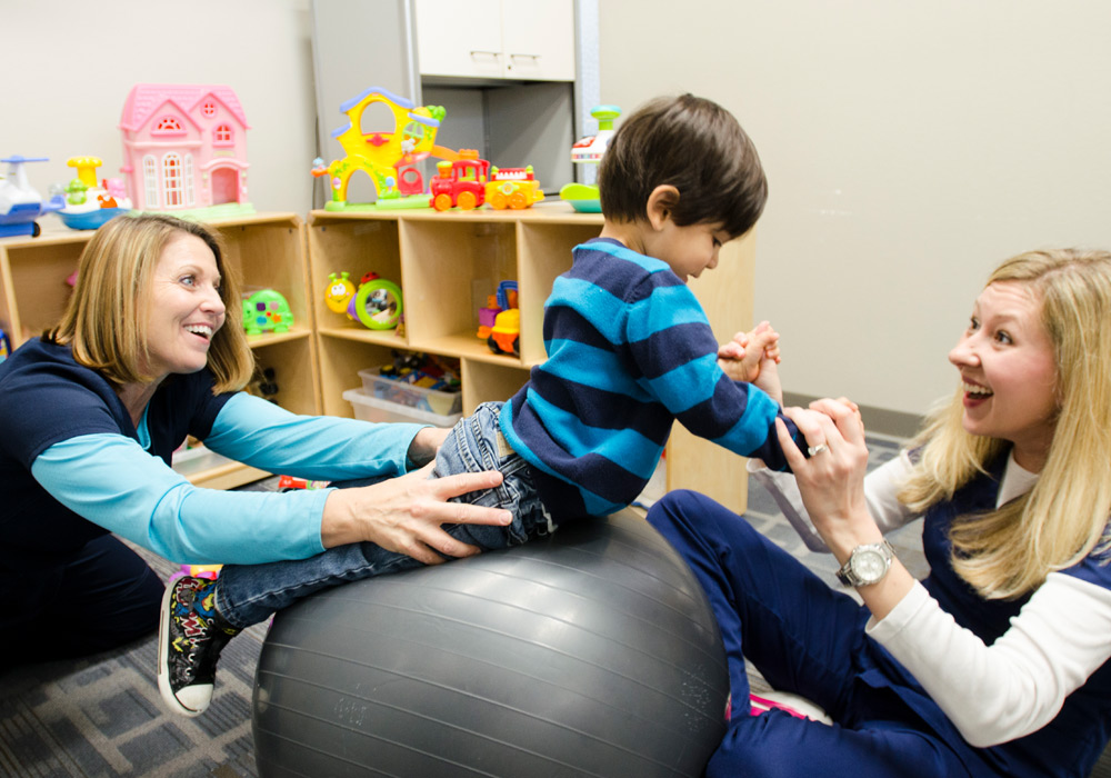 KFAC employees working with child