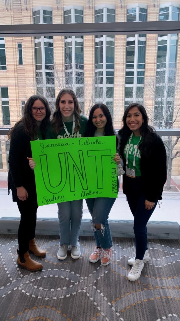 Students holding up a UNT sign