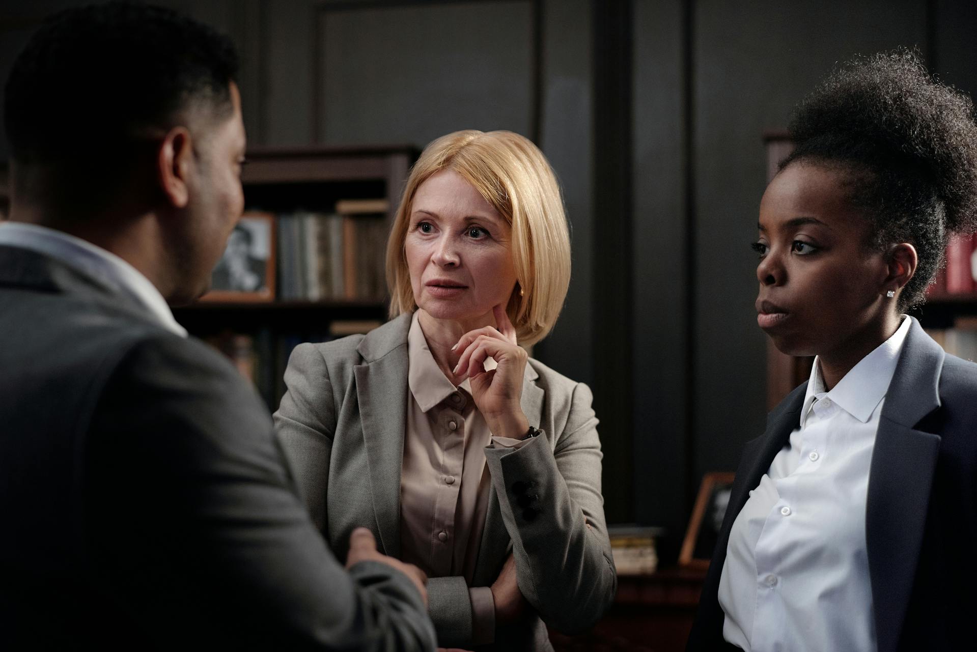 three people having conversation