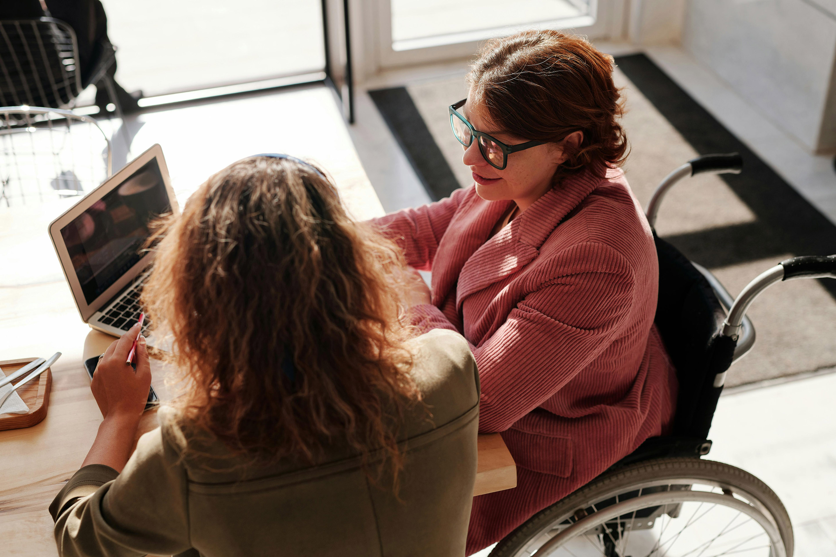 Woman in a wheelchair working with an employment counselor